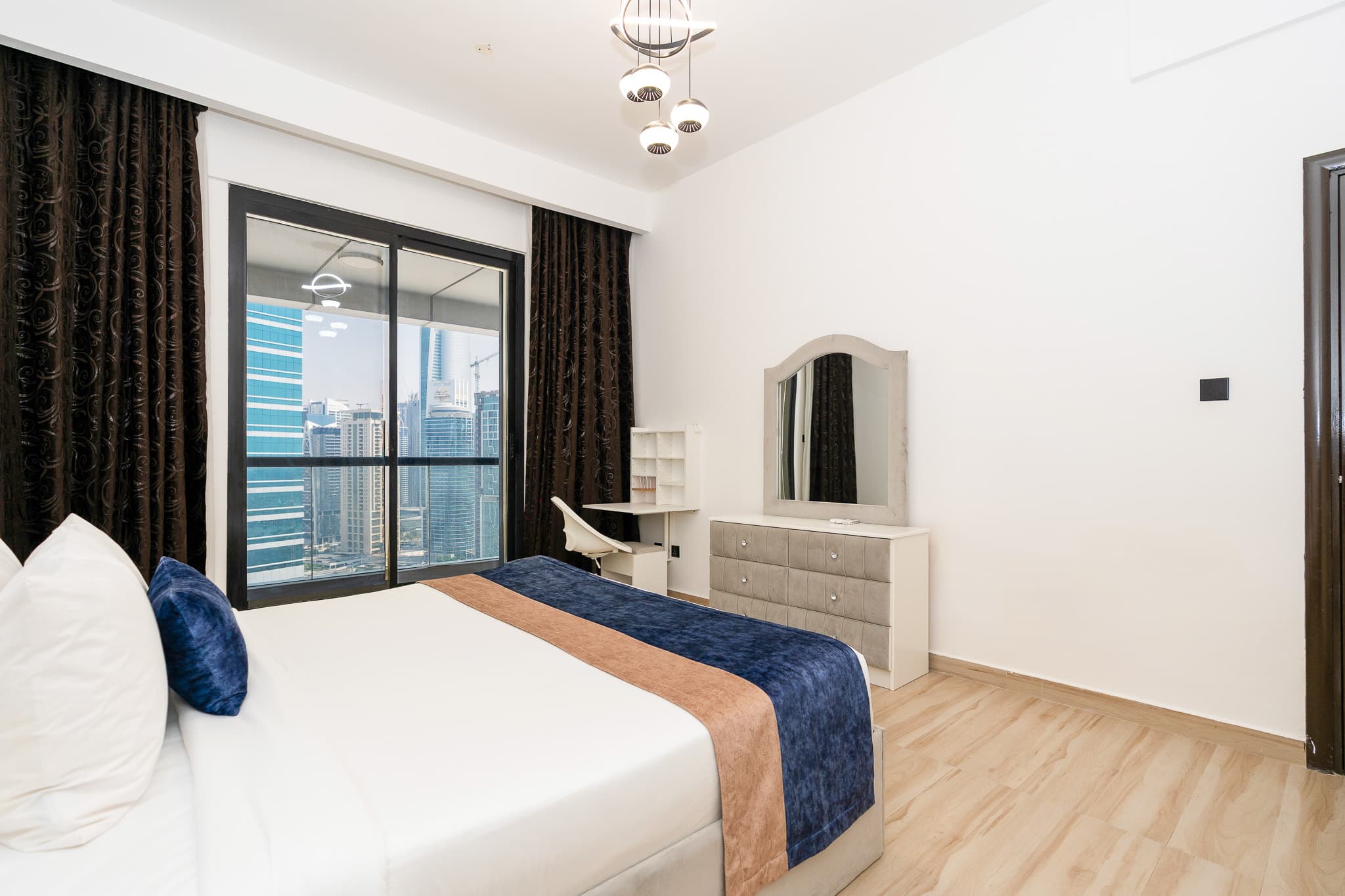 Dubai Marina apartment bedroom with marina skyline view, staged for holiday-home guests
