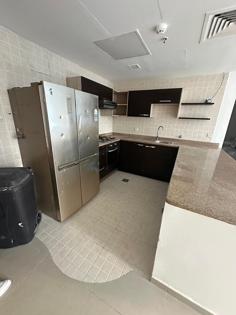 Business Bay apartment kitchen on a standard long-term lease, before Staylia managed it